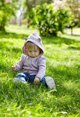 Little girl play in the park and have a good time. The concept of a happy childhood, spring outdoor recreation