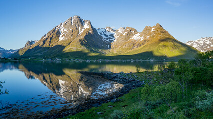 Naklejka na ściany i meble Beautiful Nature Norway natural landscape with mountain reflection on a lake.