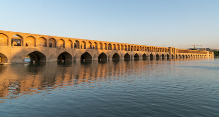 Fototapeta na wymiar Isfahan, Iran - May 2019: Iranian people on Allahverdi Khan Bridge also known as Si-o-se-pol Bridge