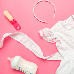 baby clothes concept. Dress for girl with baby accessories on a pink background. Flat Lay. Top view