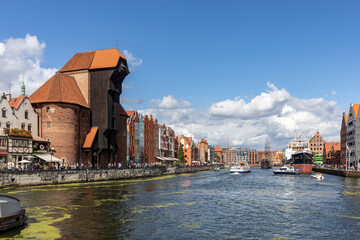 Fototapeta na wymiar The largest medieval port Crane in Europe and historic buildings on the Dlugie Pobrzeze over the Motlawa River in Gdansk, Poland.