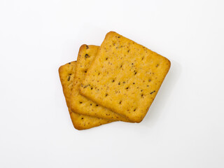 Crackers with bran and spicy herbs. Isolated on white background. Top view.