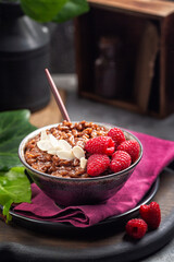 Chocolate rice porridge with raspberries and almonds.