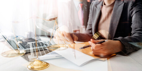 Justice and law concept.Male judge in a courtroom with the gavel, working with, computer and...