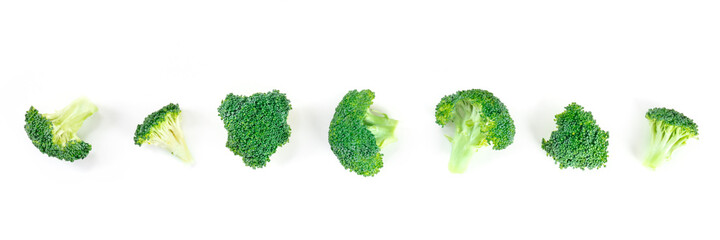 Broccoli florets panorama. Many small slices of broccoli, shot from the top on a white background....