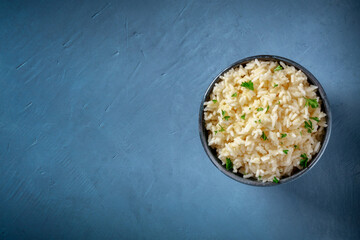 Rice, shot from above on a dark blue background with a place for text
