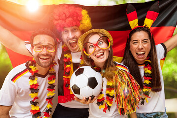 Gruppe glücklicher Fußballfans aus Deutschland feiern gemeinsam einen Meisterschaft Sieg.