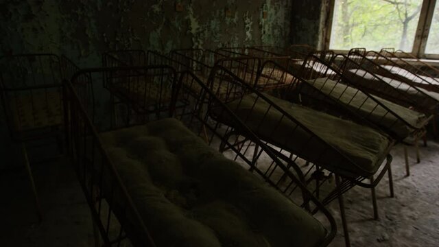 Rows of childrens beds in an abandoned hospital in Prypiat  Inside the exclusion zone of the 1986 Chernobyl nuclear disaster 