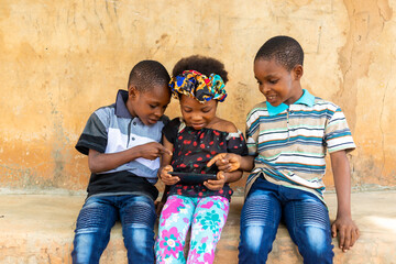 african children pointing to the mobile phone