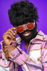 Fashion portrait of african american man in glasses against purple background