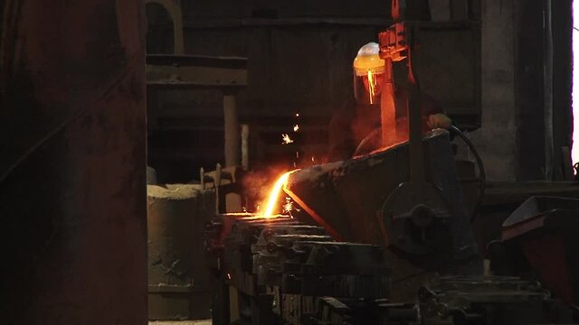 metal smelting plant. Workers remelt metal. high temperature. Cup work. 