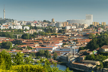 Sunset in beautiful city of Porto from Portugal. View from above with the entire cityscape during a summer day. Landmarks of Europe.
