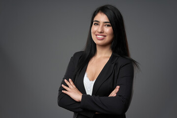 Happy businesswoman on gray background