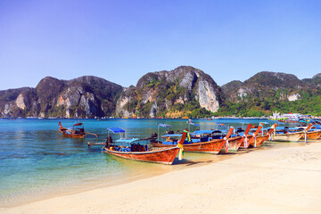 Fototapeta na wymiar Travel photo of amazing Koh Phi Phi in Thailand. Deep plus clear water, mountains and local boats in hot tropical exotic island.