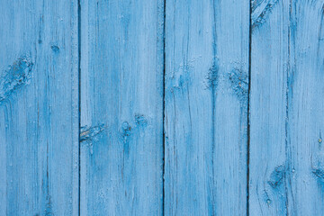 Wooden boards painted with light deep paint. The close-up conveys the texture of the slightly cracked paint over the wood grain well. The photo is perfect as a photo background