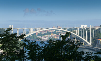 Ponte da Arrábida landmark bridge in Porto city from Portugal during a beautiful summer day with...