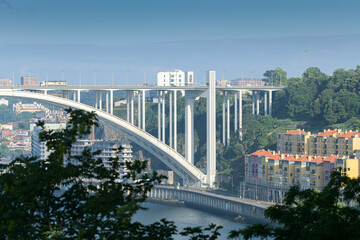 Obraz premium Ponte da Arrábida landmark bridge in Porto city from Portugal during a beautiful summer day with blue sky.