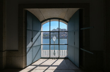 Beautiful view of Porto city from Portugal through an old window with Duero river in foreground. Landmarks of Europe.