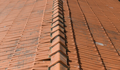 The texture of an orange tile roof building in plain sunlight