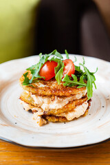 potato pancakes with sauce and vegetables