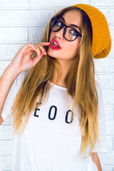 Indoor studio fashion lifestyle portrait of young sexy hipster girl