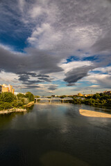 landscape in a spring day over the city bridge and the Ebro river in the Spanish city of Zaragoza