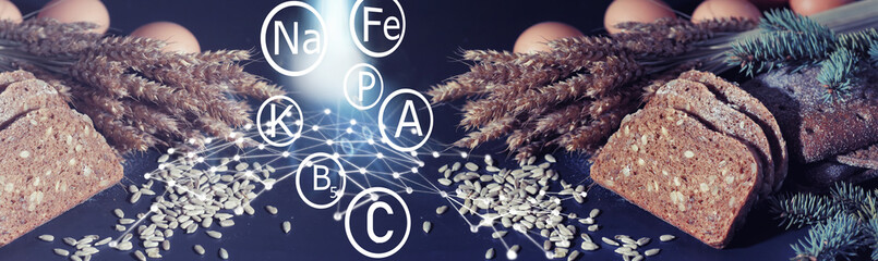 Fresh loaves of bread with wheat and gluten on a black table. Bakery and grocery concept.