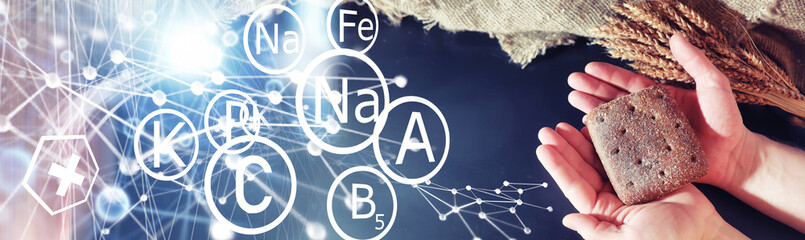 Fresh loaves of bread with wheat and gluten on a black table. Bakery and grocery concept.