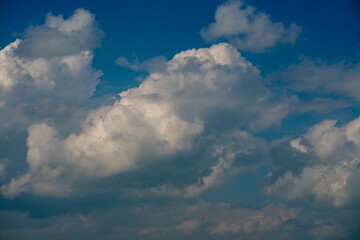 a big and fluffy cumulonimbus cloud in the blue sky