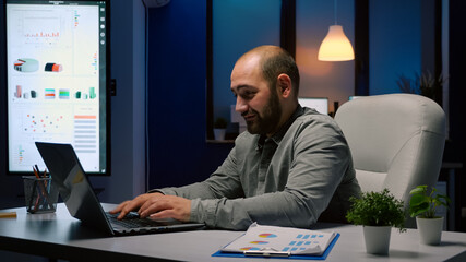 Exhausted businessman working overtime at financial company deadline project. Workaholic executive...