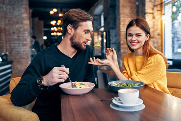 man and woman sitting in a cafe communication snack lifestyle romance