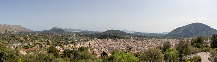 Fototapeta na wymiar Panorama city town of pollenca or pollensa in mallorca with mountain scenery background