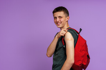Happy Smiling Vaccinated Young Man Student, With Backpack Showing His Hand With Patch After...