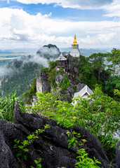 Whtie temple and pagoda on top of mountain in Thailand.