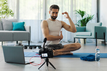 Naklejka na ściany i meble Professional vlogger recording a workout video