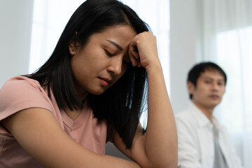 Asian women are disappointed and saddened after an argument with their husband. Asian couples are having family problems resulting in divorce. Love problem