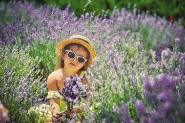 Portrait of a little girl in a field with lavender flowers