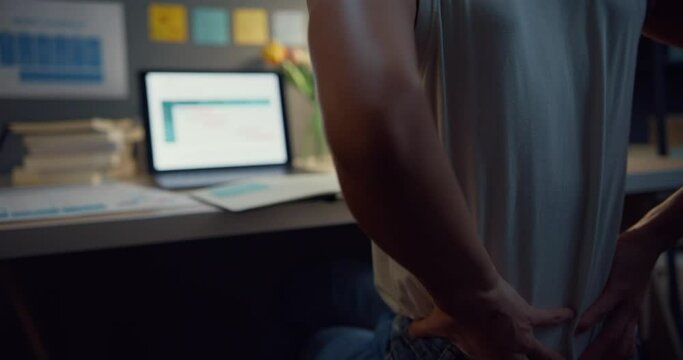Young asia business lady freelance feel tired overtime with back pain look uncomfortable while work at night. Work from house, Negative impact health life, social distance quarantine for coronavirus.