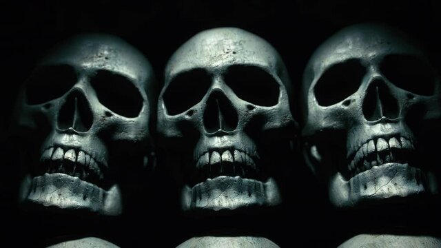 Wall of human skulls on a scary, spooky dark background