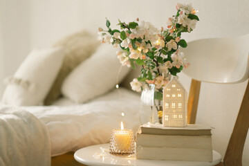 Book, candle and vase with apple spring flowers.