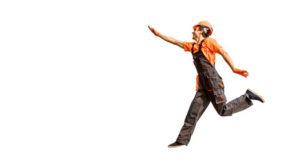 Young happy laughing caucasian man builder construction worker in a safety helmet is jumping on white background isolated.