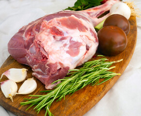 Fresh and raw meat. Leg of lamb on wood background