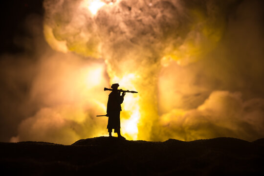 Military soldier silhouette with bazooka. War Concept. Military silhouettes fighting scene on war fog sky background, Soldier Silhouette aiming to the target at night.