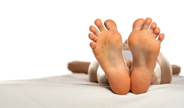 female soles on a white bed