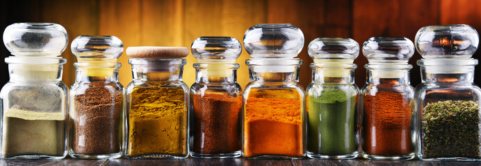 Glass storage jars with spices and herbs