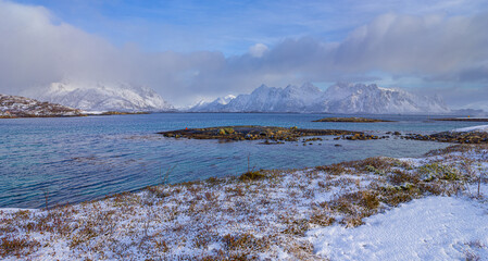 Winter landscape in north Norway: panorama image of fjord with mountains covered with freshly fallen snow