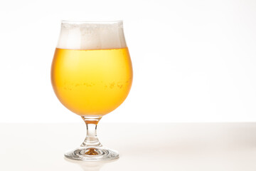 Glass of cold golden beer isolated on a white background