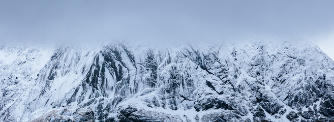 Winter landscape in north Norway: close up of a snow covered rock wall