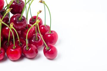 Red cherries on a white background. Sweet cherry with tails. Healthy food
