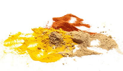 Ginger, turmeric (Curcuma) and red pepper powder pile isolated on white background